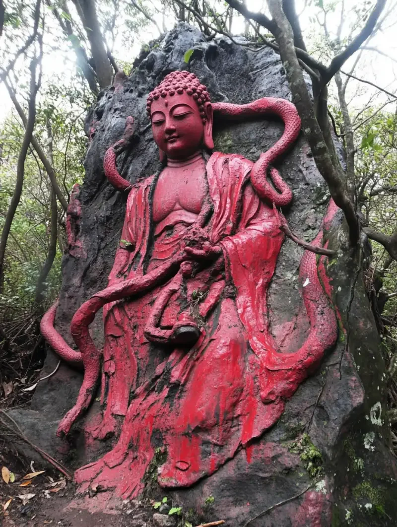 A stone Buddha abandoned in a swamp, entwined by a python, with three heads and six arms, entirely red, gigantic. --v 6.1 --ar 3:4 --style raw --s 18 --c 28