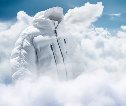 A white down jacket floats in the clouds, its zipper open, exuding vitality. --no nobody --style raw --v 5.2